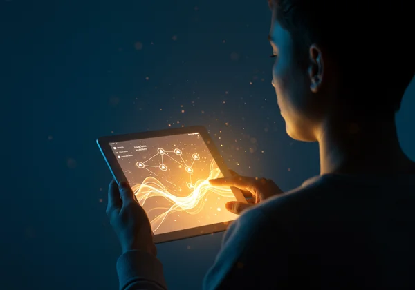 Person completing a self-assessment form on a tablet, symbolizing self-discovery.